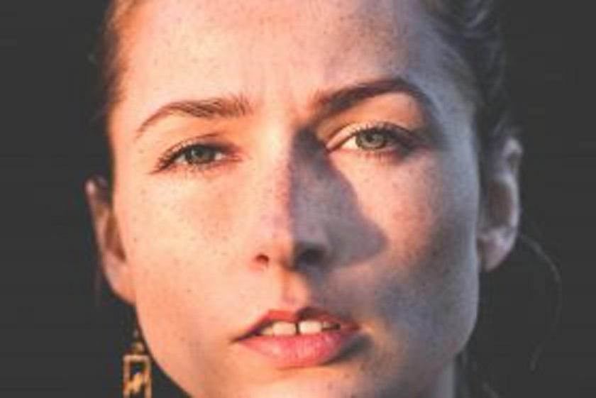 Woman looking at camera while front teeth showing