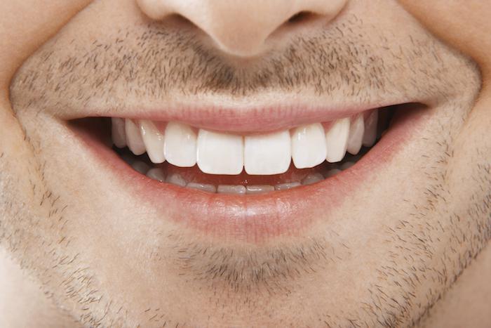 Smiling man zoomed in on mouth