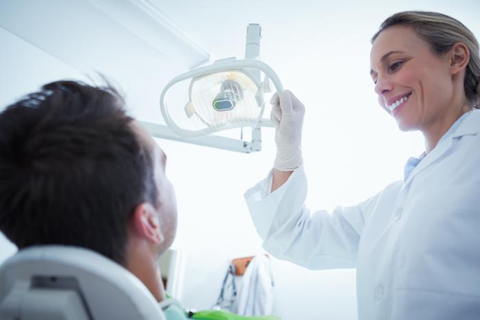 Dentist greeting patient in dental office