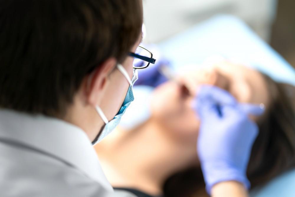 Dentist performing a dental examination on a patient